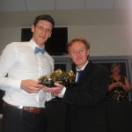 Mark Hudson receives the Golden Boot from Trust chair Tim Hartley