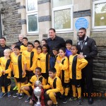 Malky with the school team at Stacey. Championship trophy is at the front